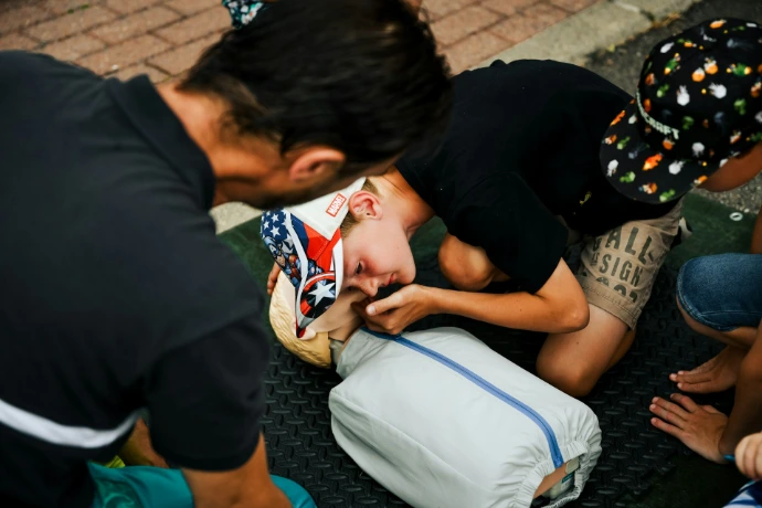 a young boy getting his hair cut by a man